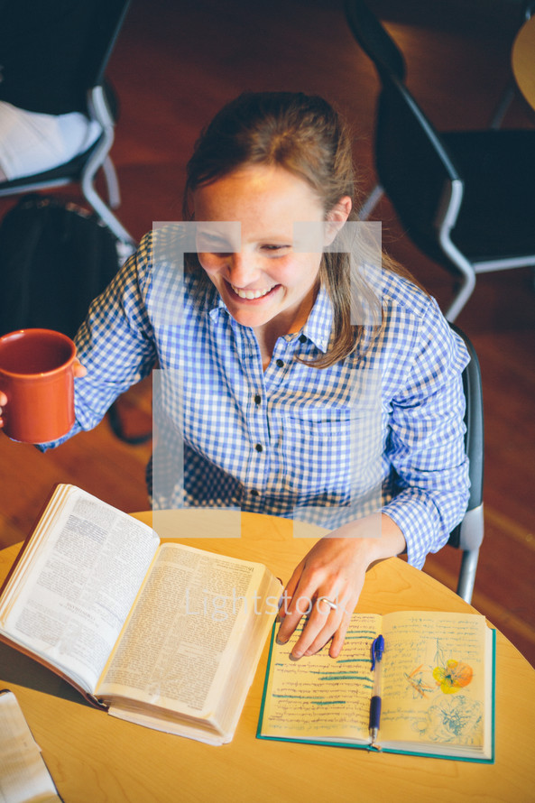 Woman drinking coffee at a Bible study.
