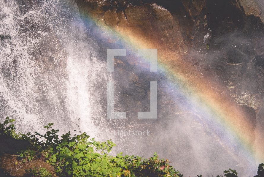 rainbow over the mist from a waterfall 
