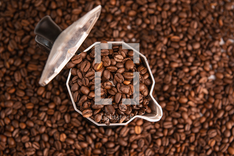 coffee beans in mocha pot on coffee beans background
