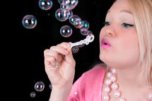 Girl blowing bubbles.