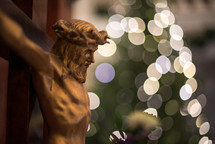 bokeh lights from a Christmas tree and crucifix in a church 