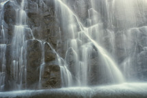 cascading waterfall down the side of a cliff 