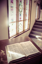 open Bible and a stained glass window 