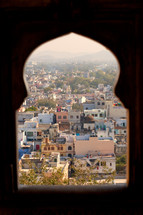 view of a shanty town in India through a window 