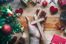 Christmas background with hand holding a cross