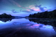 pink and purple clouds reflecting in lake water 