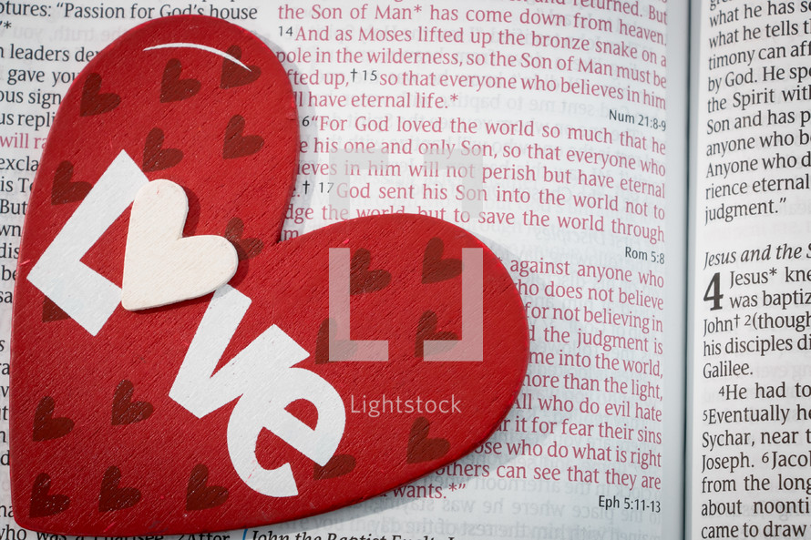 heart with the word love on a Bible 