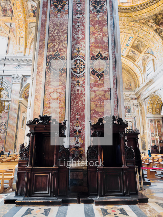 Wooden Confessionals Under Church Columns 