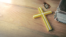 yellow cross on a wood table 