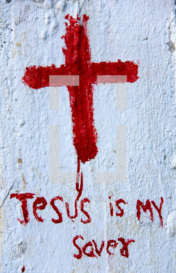 Roughly painted Christian Cross and the wording Jesus is my Savior in red paint on white background