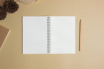 open notebook and pencil on a desk 