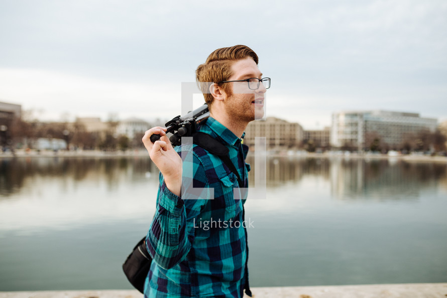 a man with a camera and tripod walking in Washington DC