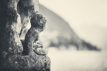 Old statue by the lake