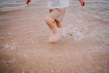 a boy running through water 