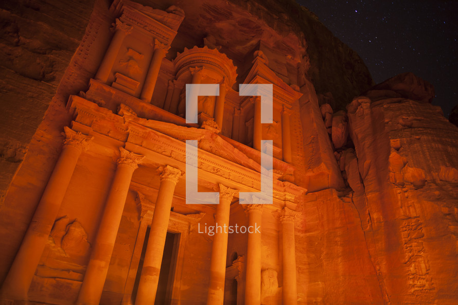 Low angle view of the treasury at night lit by candle light petra, jordan.
