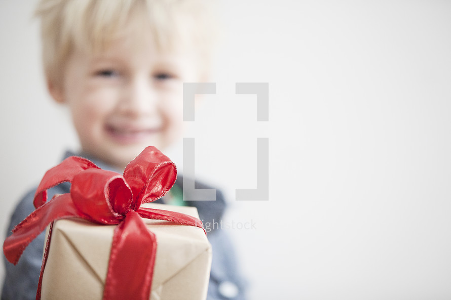 A child holding a wrapped gift. 