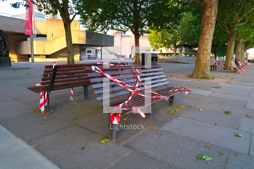 taped off benches in a city 