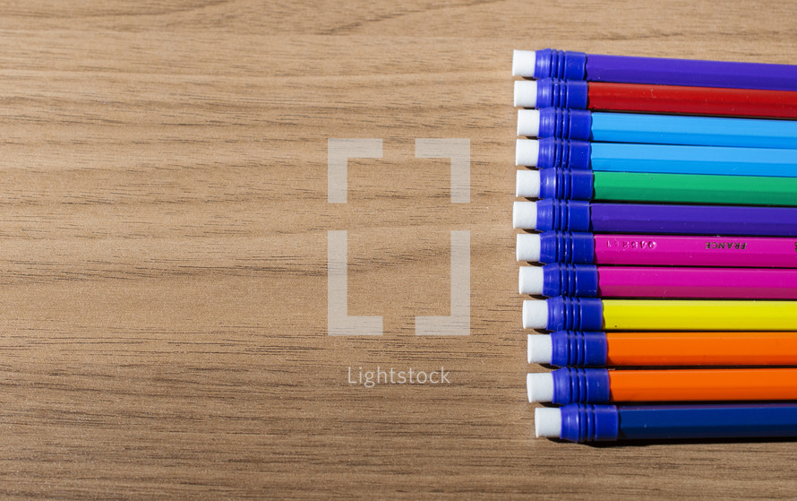 row of colorful pencils with erasers 