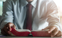 a businessman reading a Bible 
