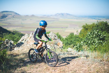 a boy child on a mountain bike exploring the outdoors 