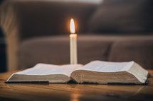 candle and open Bible 