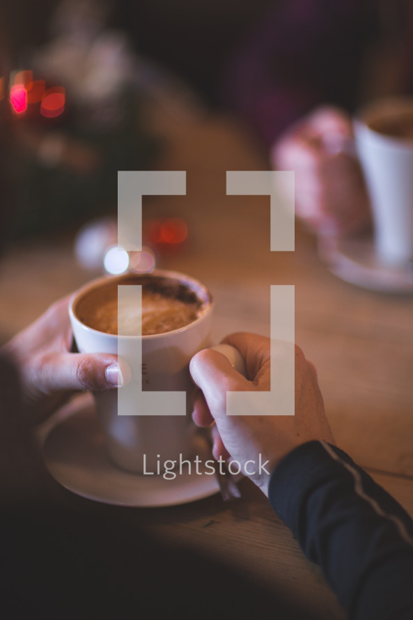 a couple drinking hot cocoa during the holidays 