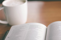 coffe cup and an open Bible
