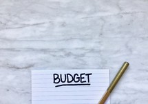 budget on a notepad and pencil 