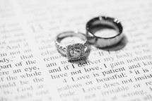 wedding band and engagement ring on the pages of a Bible