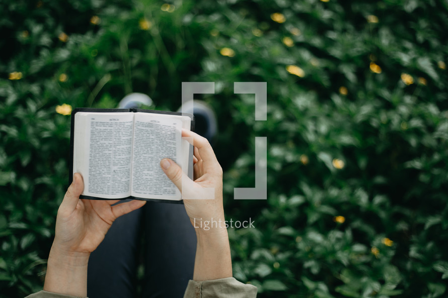a girl reading a pocket Bible 
