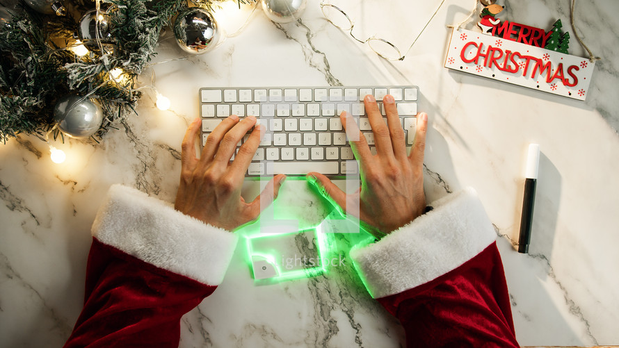 Santa buying online with a futuristic credit card
