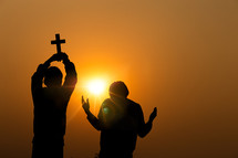 boys worshipping God at sunset 