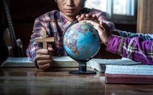 Pray for globe and people around the world of young christian group with the Cross