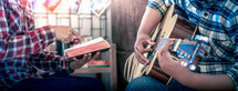 hands of young christians share a bible and sing with a guitar to worship God, Christian worship