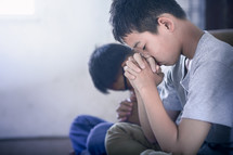 boys praying together 