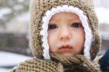 infant in a knit hat outdoors 