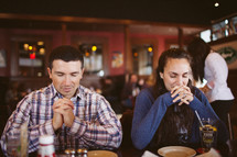 praying before a meal in a restaurant 