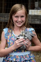 smiling child holding a bunny 