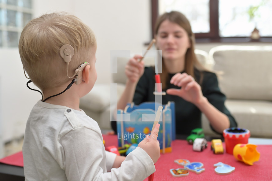 Boy With A Hearing Aids And Cochlear Implants Playing