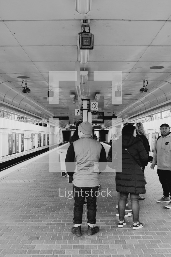 people waiting in a subway tunnel 