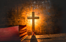 glowing cross and closed Bible 