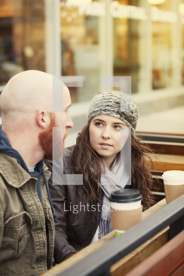 a couple talking over coffee 