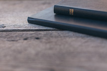 Bible and journal on a wood table 