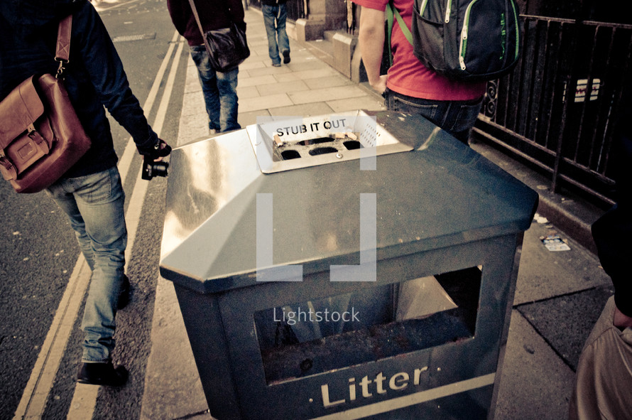 trashcan on a city sidewalk 