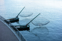 fishing nets on the back of boats 