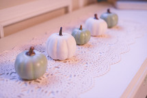 teal and white pumpkins on lace 