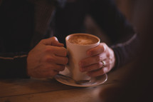 a mug holding a latte 