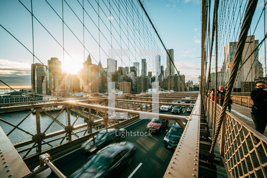 New York City bridge and buildings during sunset