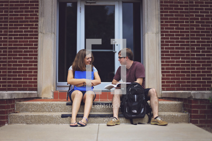 students studying on steps before class 