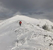 man hiking on a snowy mountain 